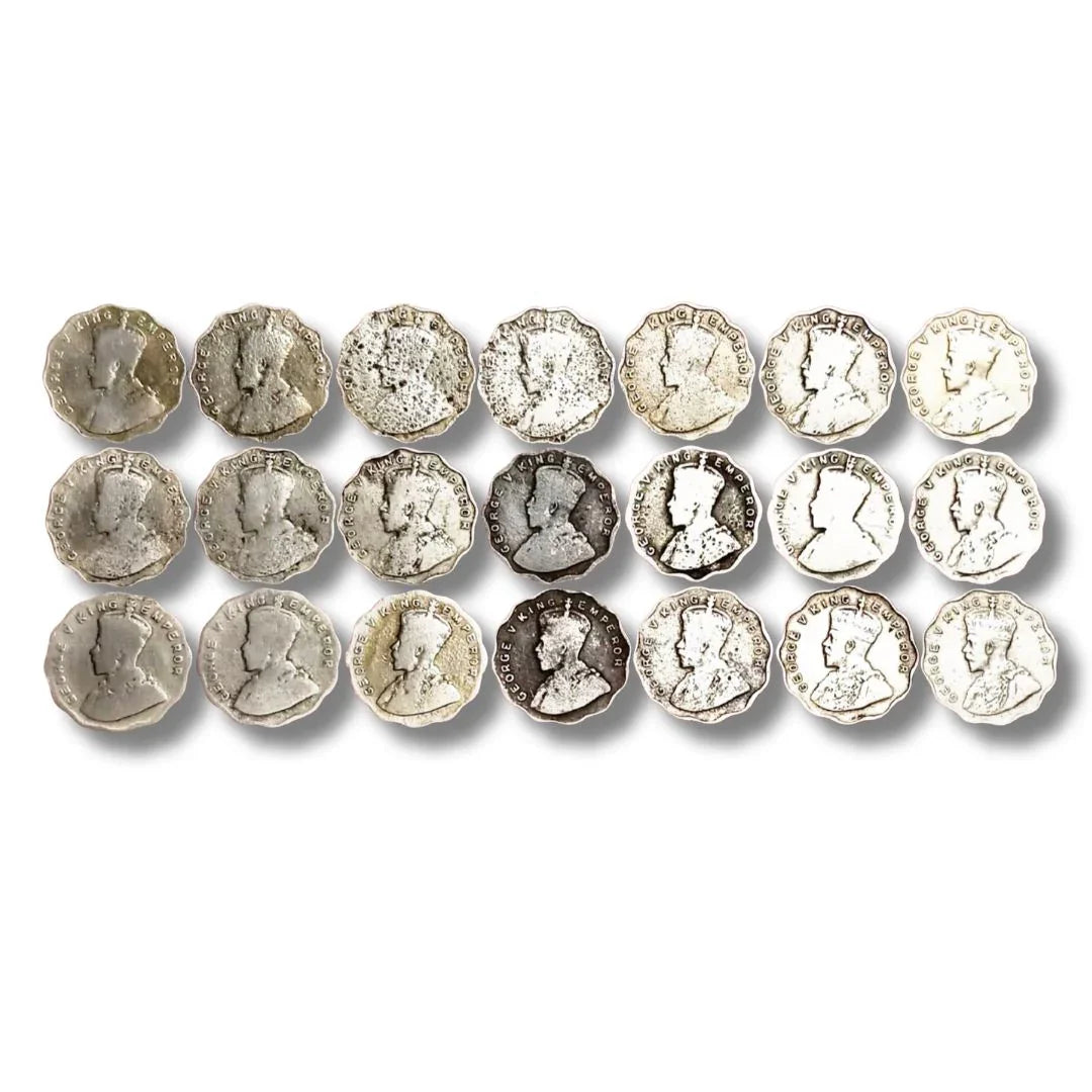 Vintage British India George V silver coins arranged in rows, collectible currency