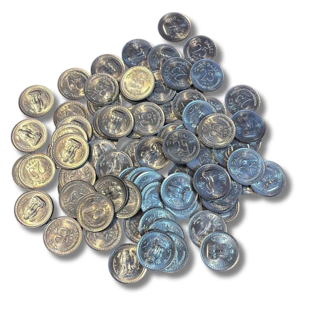 Pile of vintage Indian 25 paise coins, collectible old currency, on white background