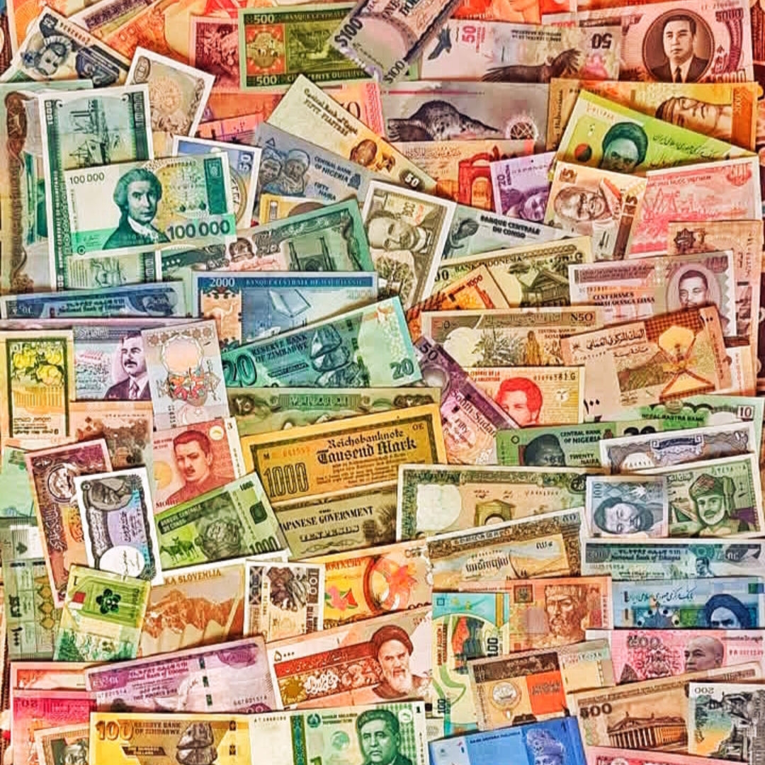 Assorted international collectible currency notes arranged in a grid, featuring various colors, portraits, and designs from different countries.