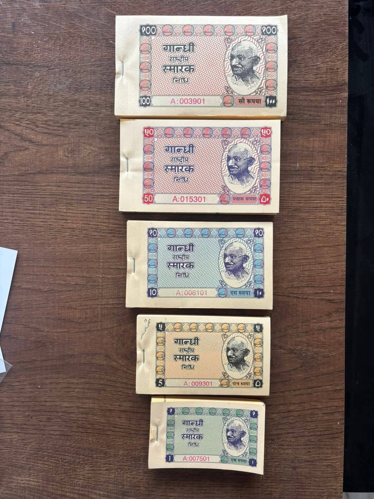 GANDHI SMARAK NIDHI 

================

SET OF 5 DIFFERENT DENOMINATIONS

100 NOTES IN EACH PACKET 

BOOK ALL 5 BUNDLES - Collection Bazzar