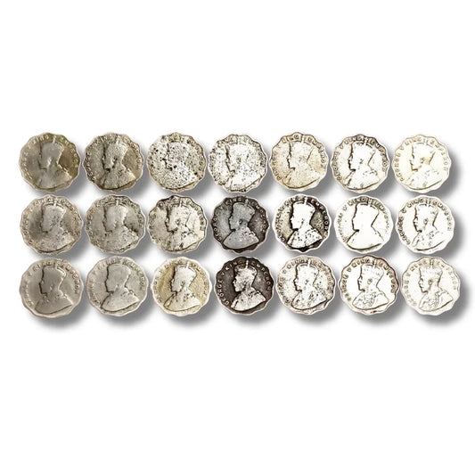 Vintage British India George V silver coins arranged in rows, collectible currency