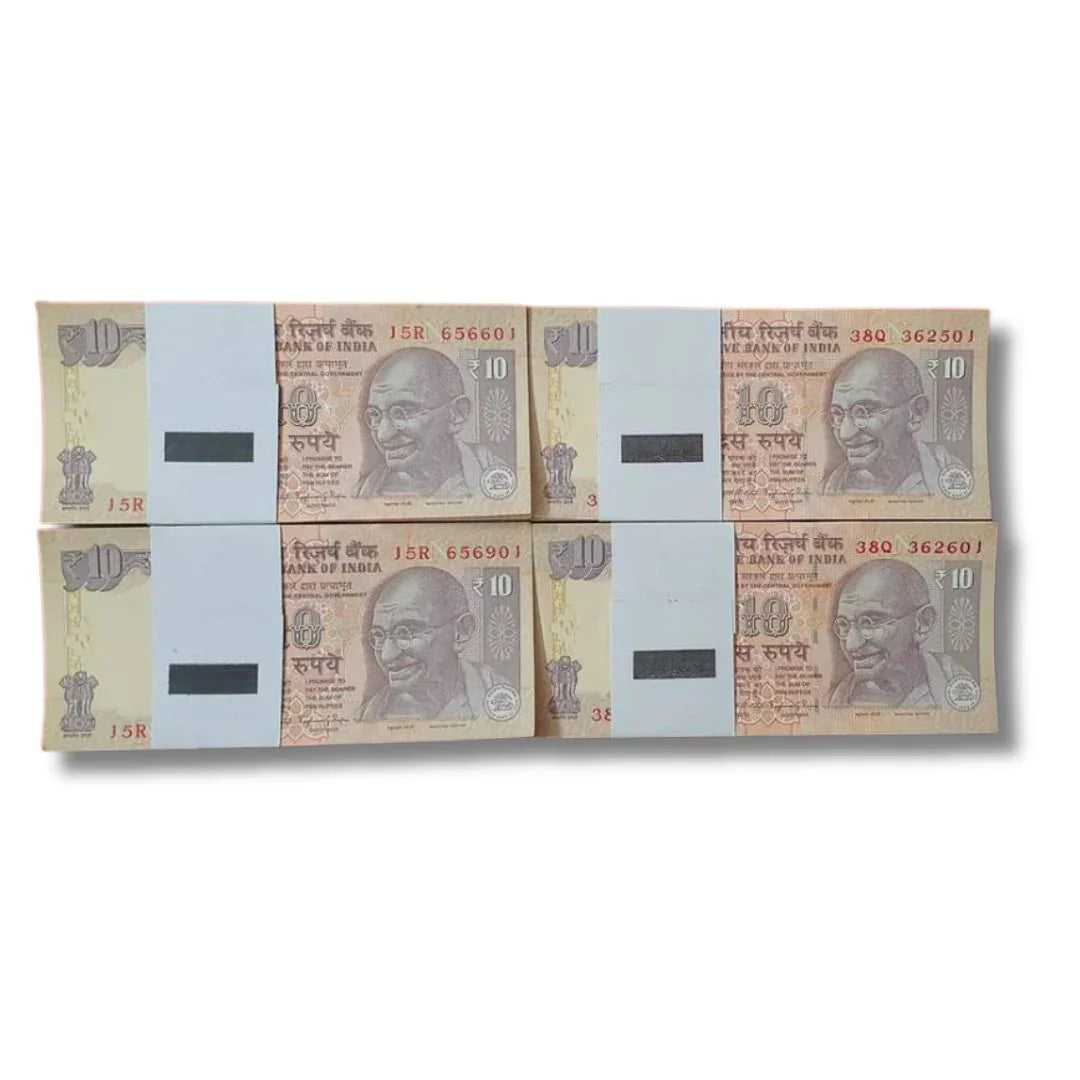 Multiple bundles of Indian 10 rupee banknotes in uncirculated condition on white background