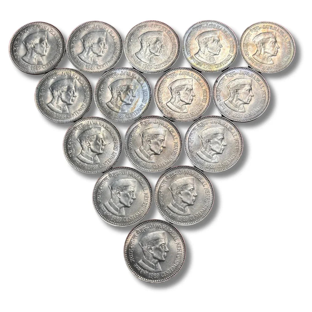 Vintage Indian commemorative coins with Jawaharlal Nehru portrait arranged in a triangle
