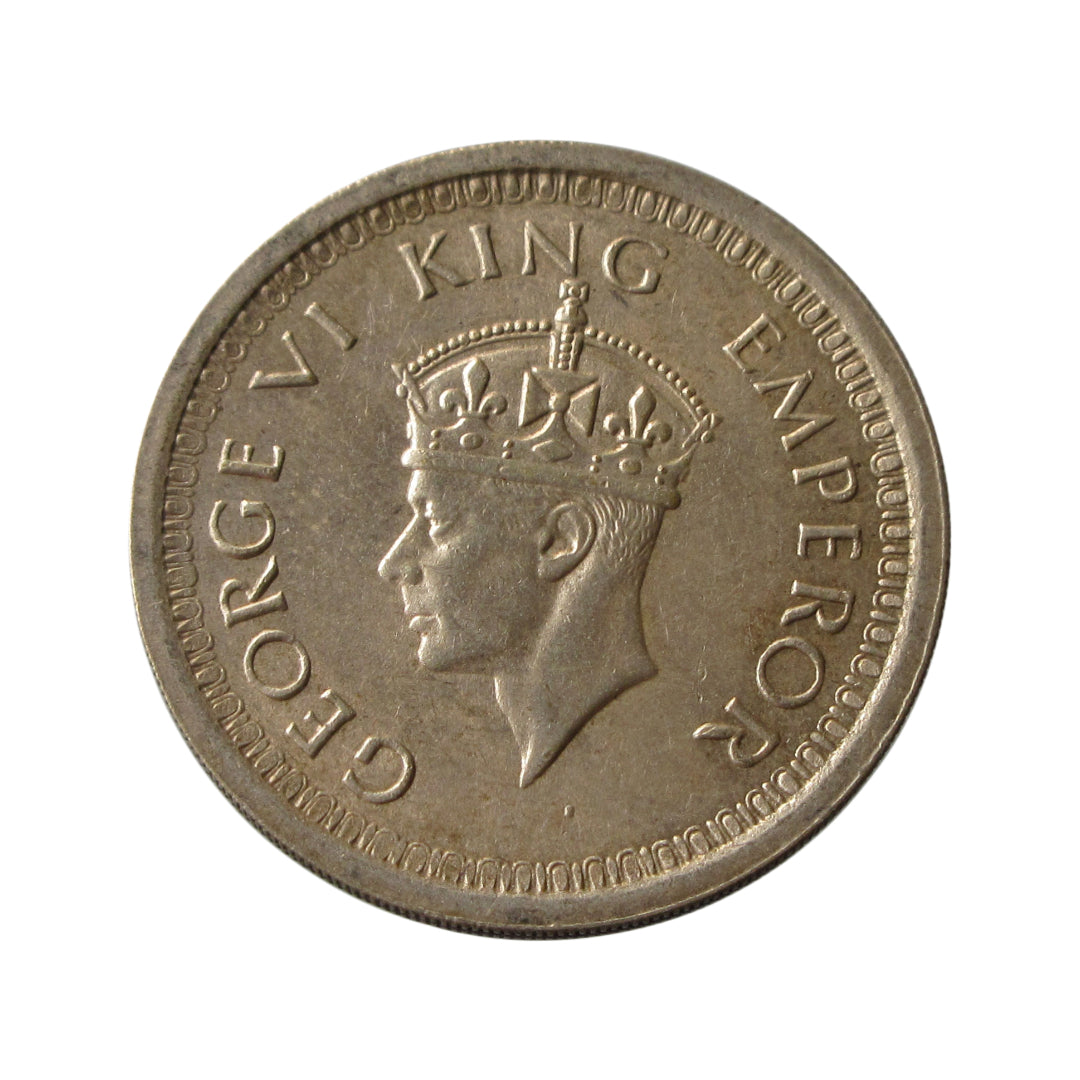 1944 One Rupee British India silver coin featuring George VI portrait and floral wreath reverse design.