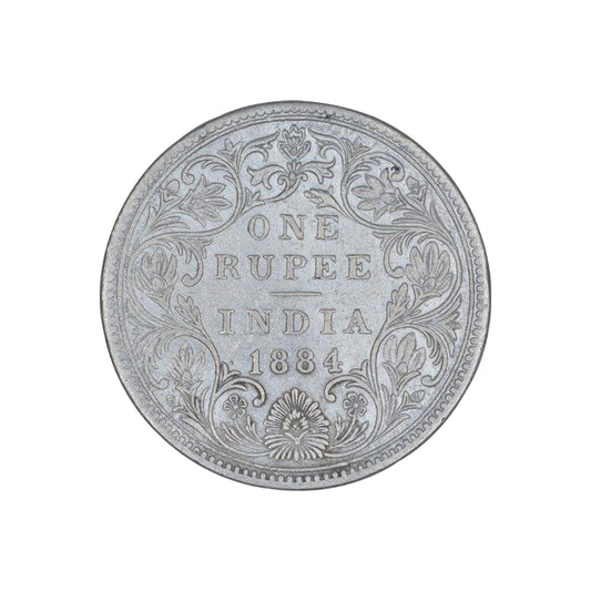 Rare 1884 India one rupee silver coin featuring Queen Victoria Empress with floral wreath reverse design, collectible British India coin.