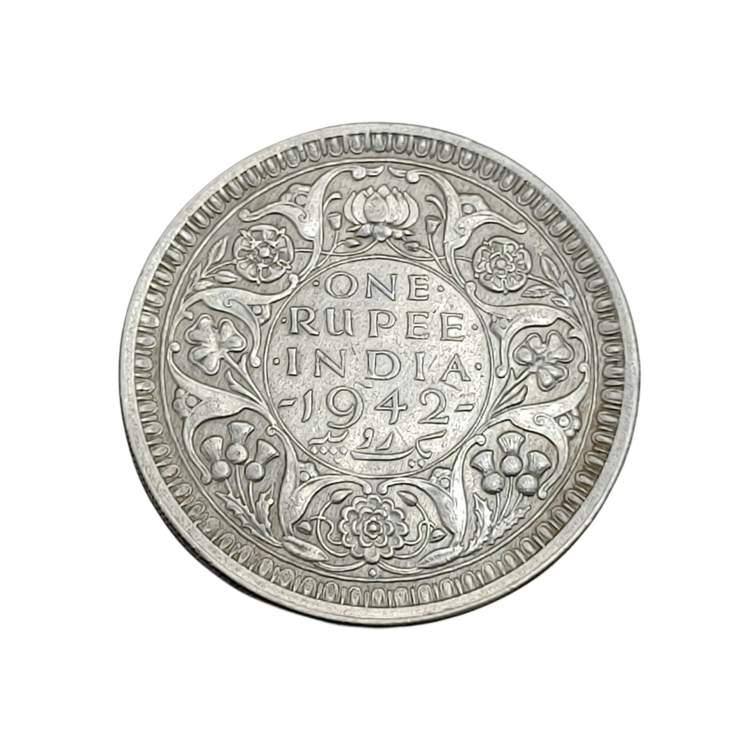 1942 India one rupee silver coin featuring King George VI with floral wreath reverse design, rare British India collectible.